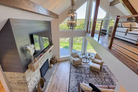 An open-concept living space remodeled by ISM Construction removing dividing walls to create a bright, connected kitchen, dining, and family room area.