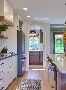 A kitchen featuring a refrigerator and a stove, showcasing a functional cooking space.