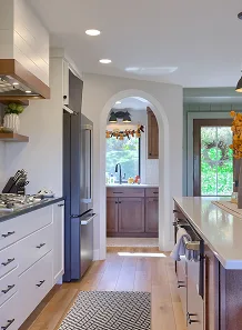 A kitchen featuring a refrigerator and a stove, showcasing a functional cooking space.