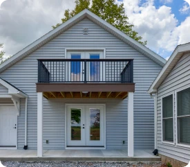 A new second-story addition featuring an outdoor balcony with black railings, completed by ISM Construction, experts in Second-Story Additions in Lebanon, PA.