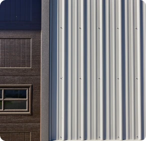 Close-up architectural detail of vertical metal panel siding and a building corner seam, installed by ISM Construction for Custom Garages in Lebanon, PA.