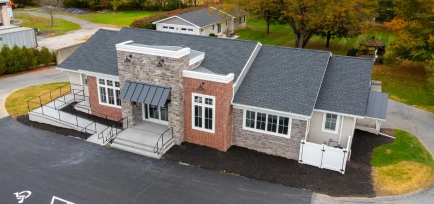 High-angle aerial perspective of a modern commercial office facility and parking lot, managed by ISM Construction, a General Contractor in Lebanon, PA.