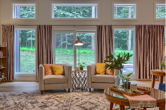 A cozy living room featuring a couch, a chair, and a table arranged for relaxation and socializing.