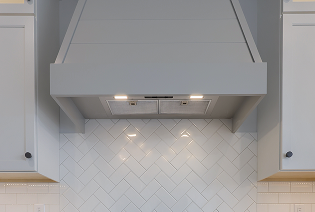 A layered kitchen lighting design by ISM Construction combining task, ambient, and accent lighting to create the perfect atmosphere for any occasion.