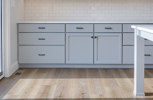 Custom kitchen cabinetry installed by ISM Construction featuring smart storage solutions including pull-out pantries, deep drawers, and integrated organizers.