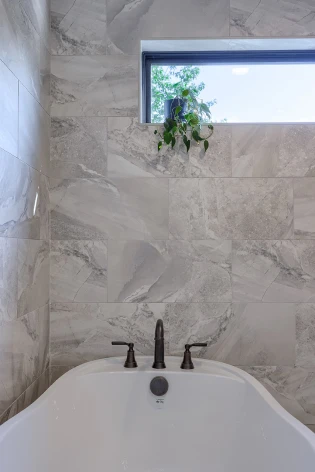 Modern water-efficient toilets and faucets installed by ISM Construction combining elegant design with environmentally responsible performance.