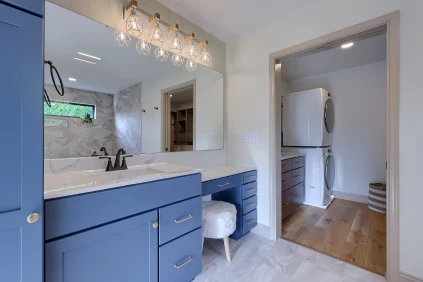 A custom-built bathroom vanity by ISM Construction featuring ample storage and smart organizational features for a serene, clutter-free space.