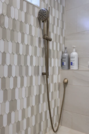 A spacious walk-in shower with multiple showerheads and a freestanding soaking tub built by ISM Construction, creating a spa-like escape in a Lebanon County home.