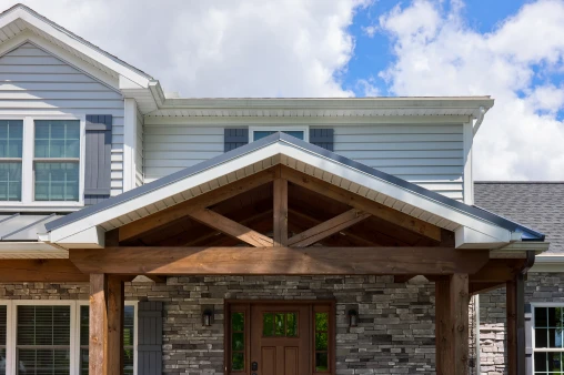 A beautifully crafted front porch and portico added by ISM Construction to a Mount Zion project, creating a welcoming architectural focal point.