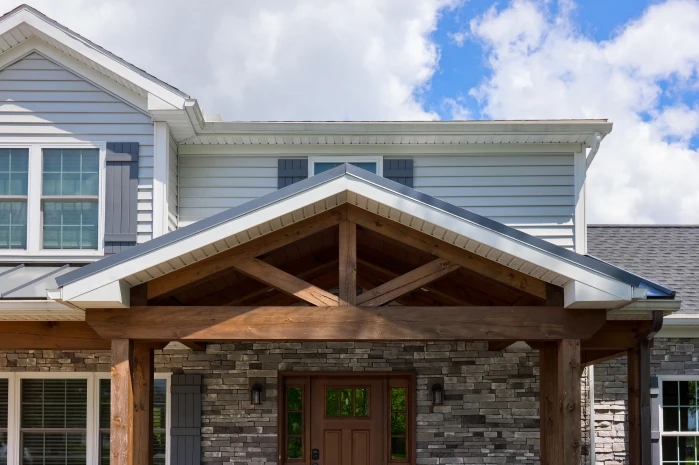 Home exterior showcasing a timber-framed porch gable roof and upper-level remodel by ISM Construction, a specialist in Second-Story Additions in Lebanon, PA.
