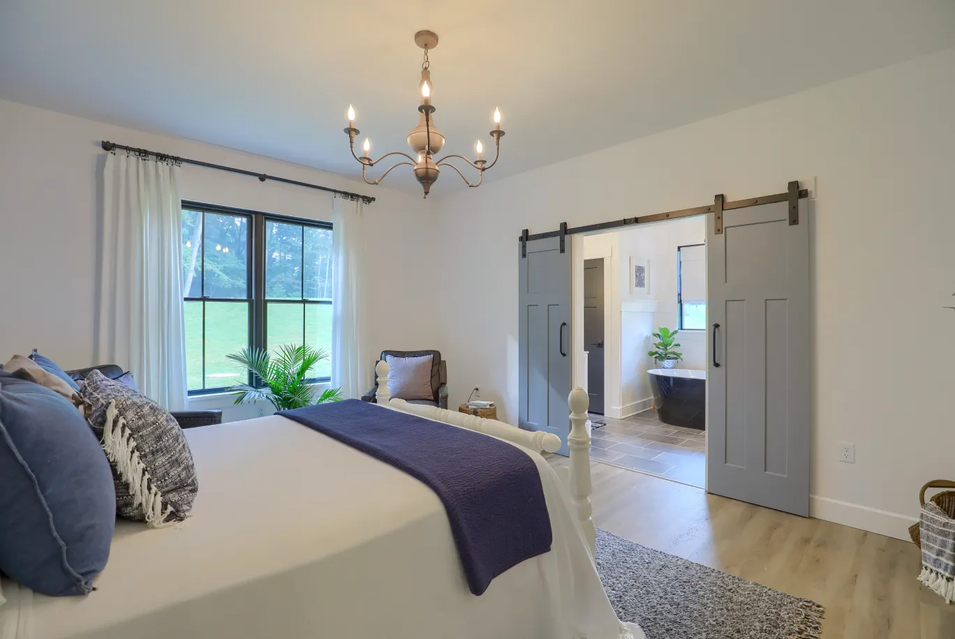 A luxurious primary suite addition by ISM Construction featuring a spa-like bathroom, oversized walk-in closet, and a bedroom designed for ultimate relaxation.