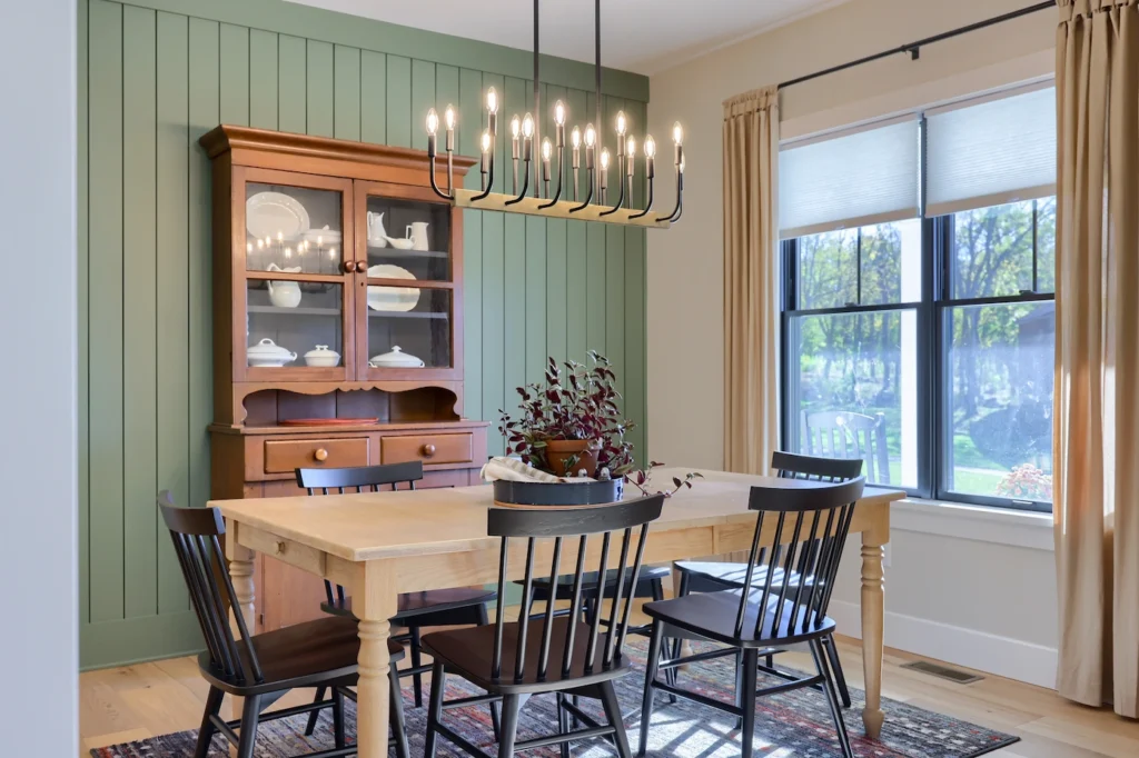 A well-set dining room table featuring elegant tableware, a centerpiece, and comfortable chairs around it.
